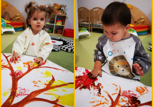 Rozalia i Kobi odciskają dłonie pomalowane farbami tworząc jesienne drzewo.