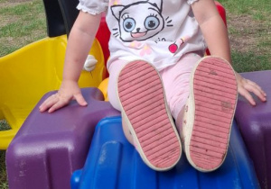 Laura pozuje do zdjęcia podczas zabawy na placu zabaw.