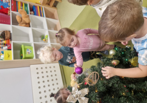 Nicolas, Zosia wraz z innymi dziećmi ubierają choinkę.