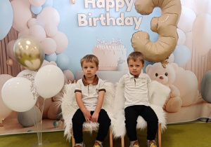 Marcel i Oliwier pozują do pamiątkowego zdjęcia z okazji urodzin.